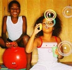 Young Girl (8-10) Blowing Bubbles and Young Boy (10-14) on Inflatable Bouncing Ball j0422735 231x225 Home